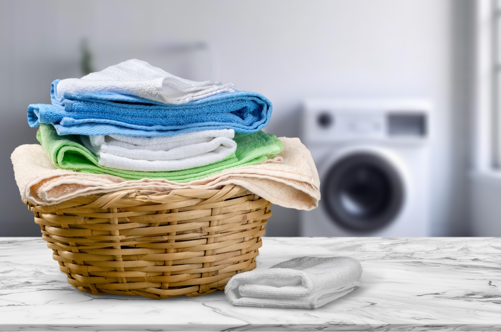 Basket of folded towels on a work surface