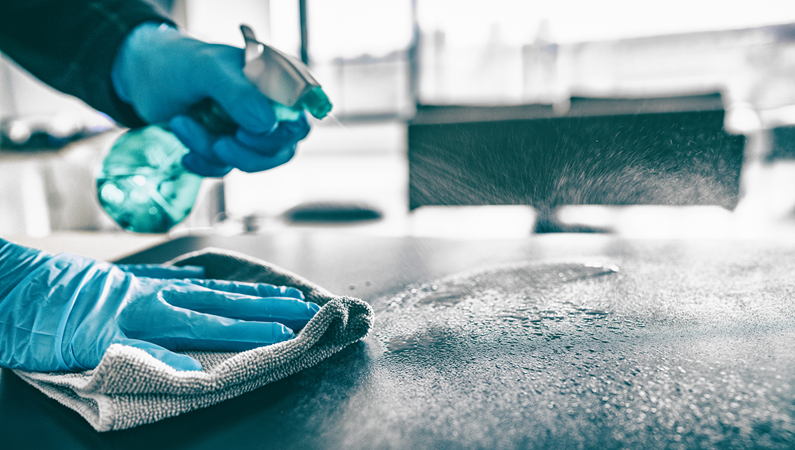 Two people cleaning a kitchen space